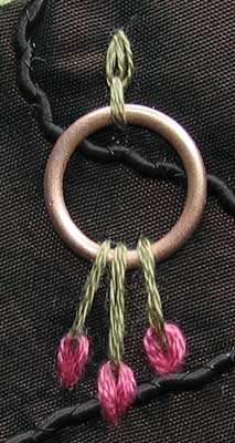 gold ring held in place with detached chain stitch